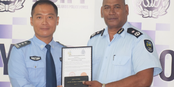 RSIPF Commissioner present certificate to Deputy Commissioner Li Bing. Photo supplied.