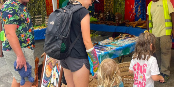 Tourists from the Pacific Explorer tourist boat looking at some local arts and craft. Photo, Visit-Solomon-Islands.