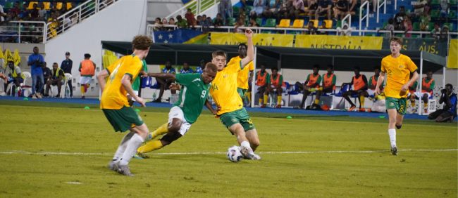 Action clash – Jimson Abana try to goes pass two Australian defenders. Photo by Raymond Hulanga.