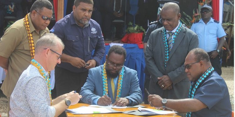 Premier Asilaua (center) signing the MoU on the Australian Government-funded Malaita South Road Rehabilitation Project