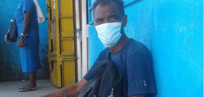 35-year-old Laua sitting in front of Chinese shop in Honiara where he works at