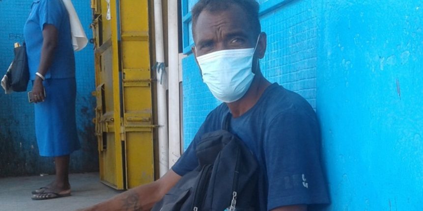 35-year-old Laua sitting in front of Chinese shop in Honiara where he works at