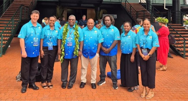 Hon. Tovisia flanked by members of Solomon Islands delegation