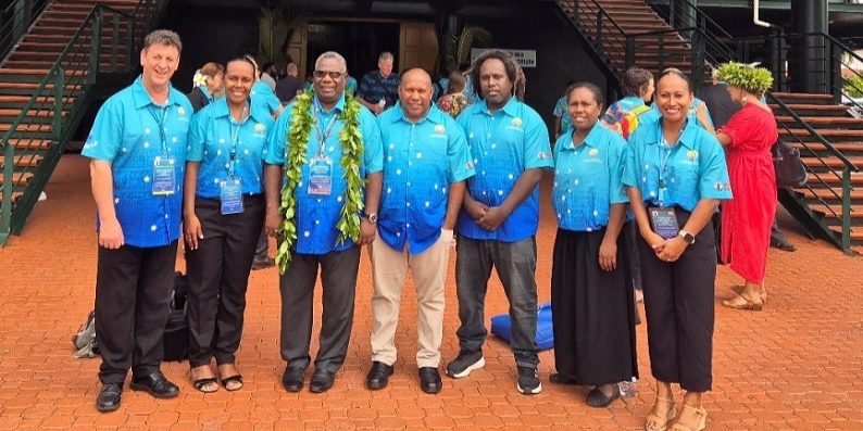 Hon. Tovisia flanked by members of Solomon Islands delegation