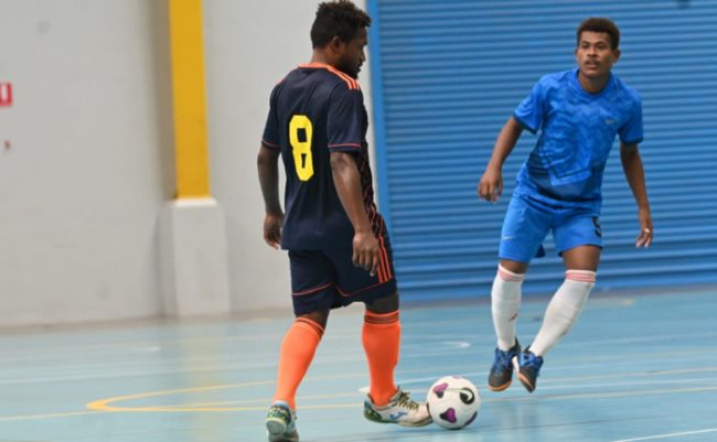 Jeffery Bule of Futsal G.C with the ball while a Kukstaon players looks on. photo by Floyd Terry.