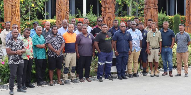 Minister Maelanga (standing 6th from right) with facilitators and participants