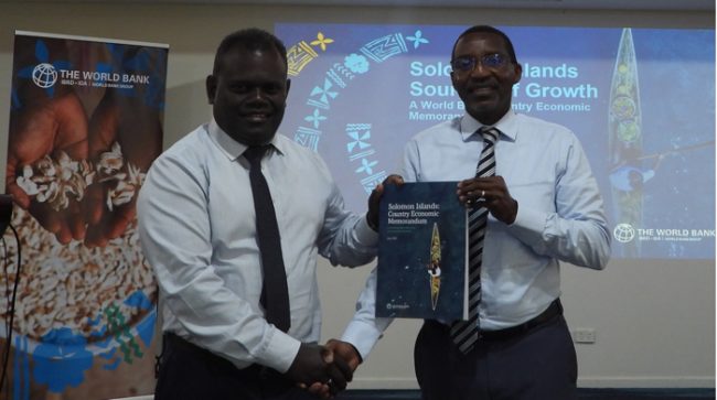 MoFT PS McKinnie Dentana (left) and World Bank Country Director for PNG and the Pacific Islands, Stephen Ndegwa with the launched Country Economic Memorandum & Source of Growth Study Report