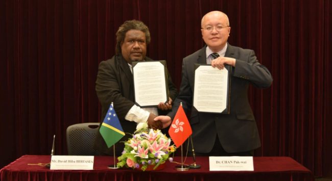 Mr Hiriasia of SIMS and Dr Pak-wai of the Hong Kong Observatory with the signed MoU documents. Photos supplied