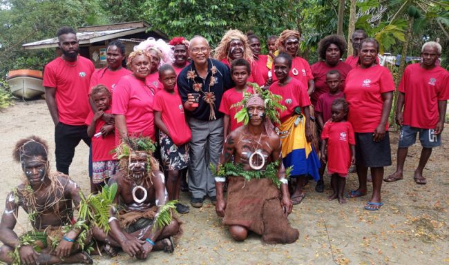 Nusa Mahiri Warriors and Community Members with ADRA Director Leyn E Gantare take photo after the welcoming ceremony.