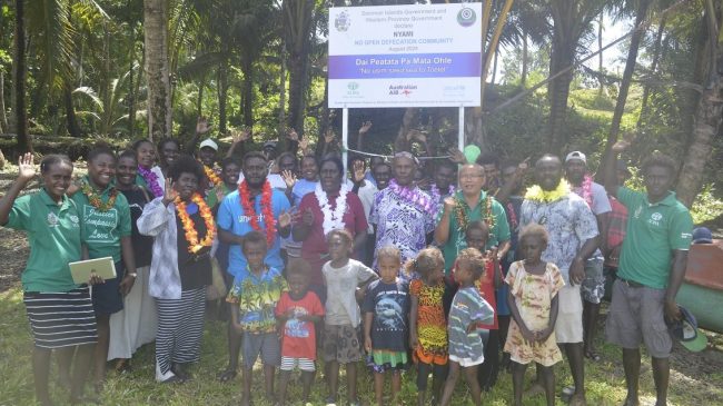 Pidaka communities together with the ADRA team distiguished guest pose for a group photo
