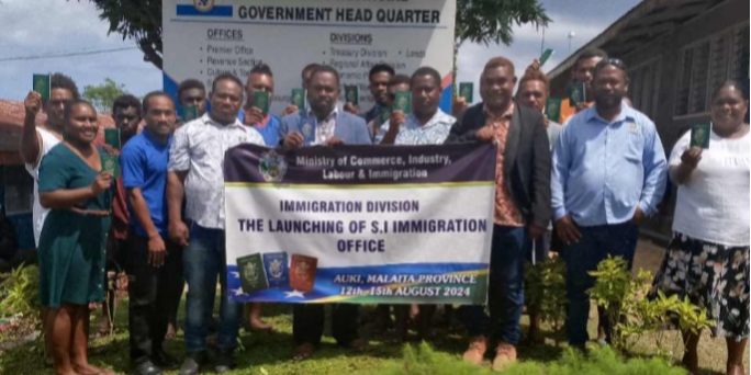 Premier Asilaua and Provincial Secretary George and other MPG officials posing with the first 24 Malaita-based passport applicants in Auk