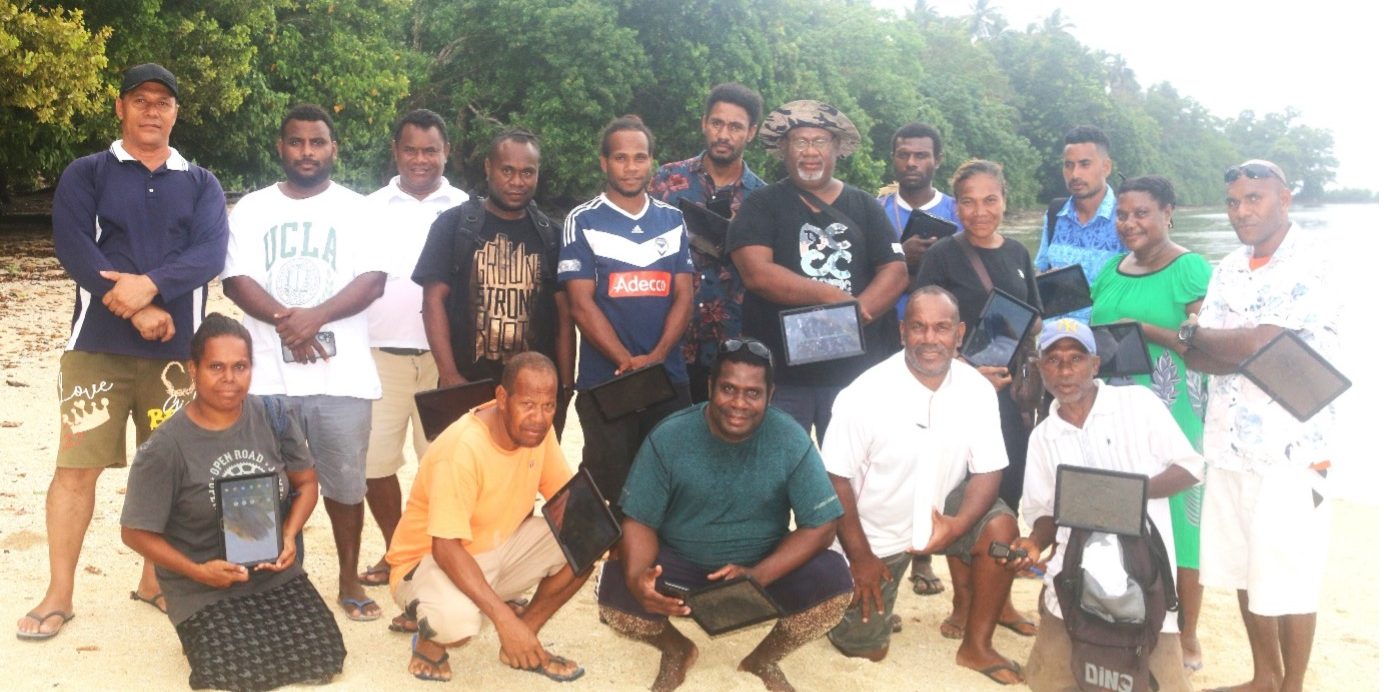 Temotu WSOs pose with their tablets with MPGIS and Temotu Provincial Trainers at Louva Beach after their practical data collection interviews with the Louva community on July 26th, 2024