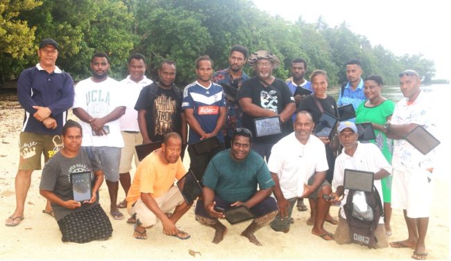 Temotu WSOs pose with their tablets with MPGIS and Temotu Provincial Trainers at Louva Beach after their practical data collection interviews with the Louva community on July 26th, 2024