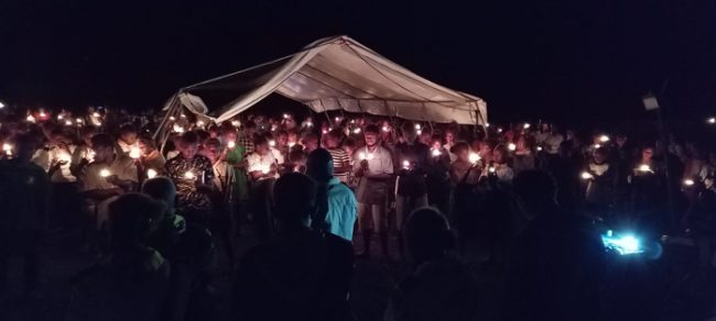Young youths light their candles and make promises to shines to others in their communities. Photo by Harry Samuel