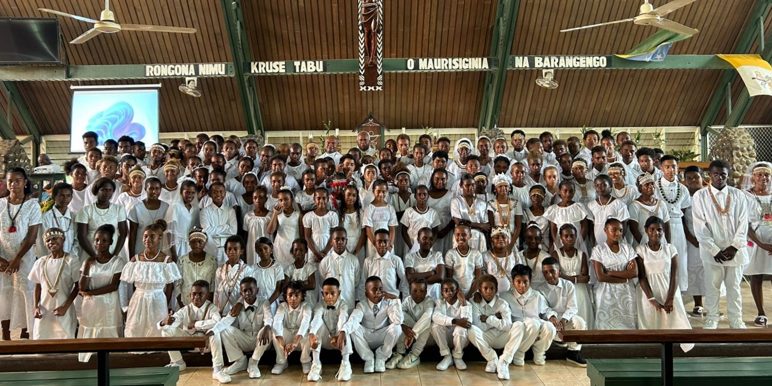 A group photo featuring Fr. Peter Kevin and Fr. Clement Wane during the celebration.