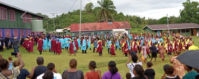 Graduates gather in a circle at the school grounds (2)
