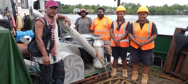 Pius Itea (far left left) with TTC workers on the ship to assist in transporting the project equipment to the project site in Falake village. Photo by Solomon Lofana