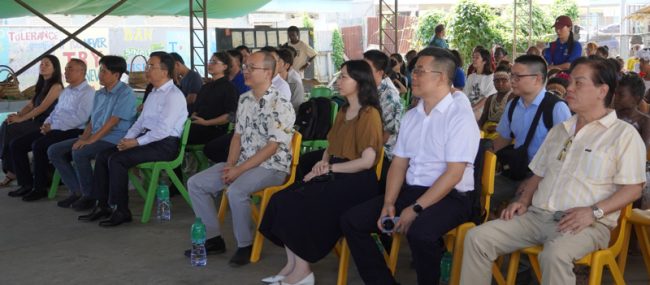 The Jiangmen delegation and officials from the Chinese Embassy watching cultural dances put on by students