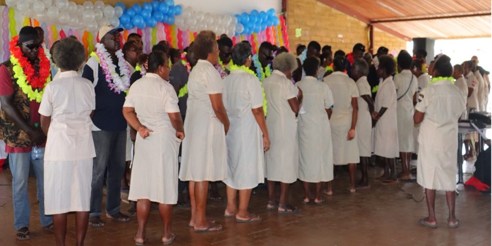 Dorcas of the Honiara District Churches garlanding the 26 released inmates