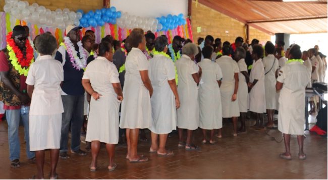 Dorcas of the Honiara District Churches garlanding the 26 released inmates