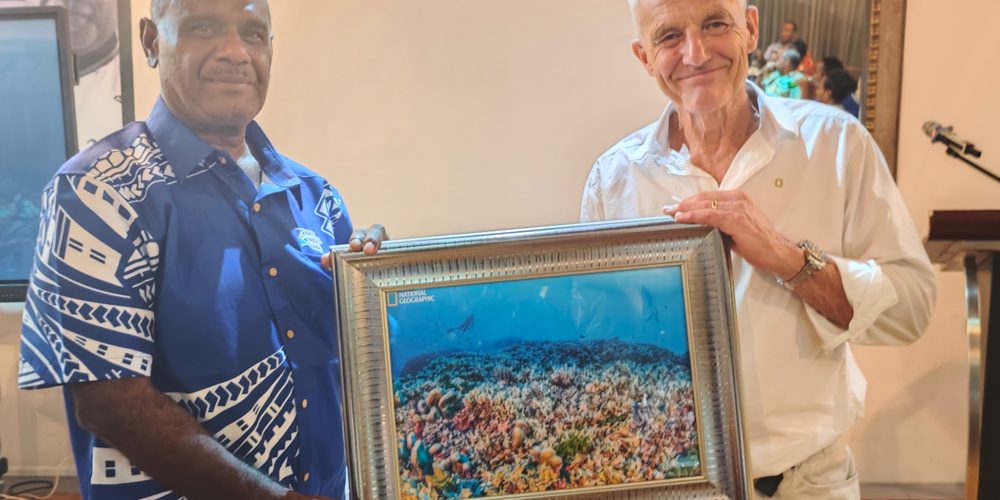 Prime Minister Manele received a gift (the photo of the largest coral in the world) from Molly Timmers, the lead scientist of the expedition