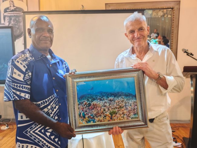 Prime Minister Manele received a gift (the photo of the largest coral in the world) from Molly Timmers, the lead scientist of the expedition