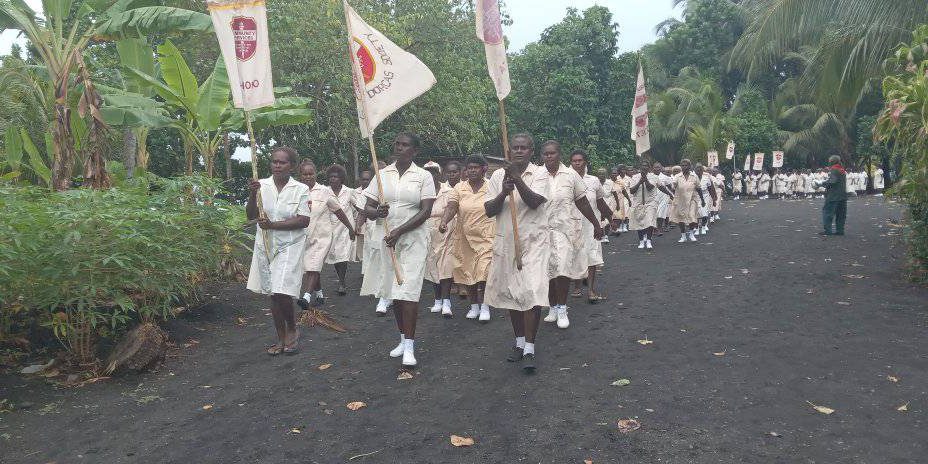 Some Dorcas carrying the Dorcas flags during the march past
