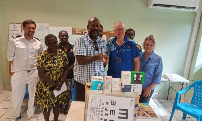 The official handing over of the medical equipment from Collun Scobie to Dir Dickson Boara WP Health Director as other members look on