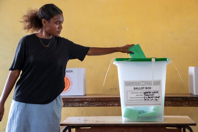 Young voter casting her ballot paper at Gilbert Camp polling station