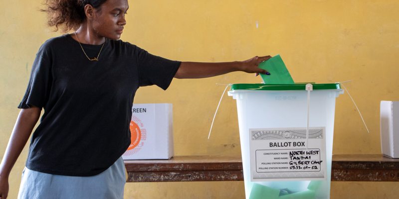 Young voter casting her ballot paper at Gilbert Camp polling station