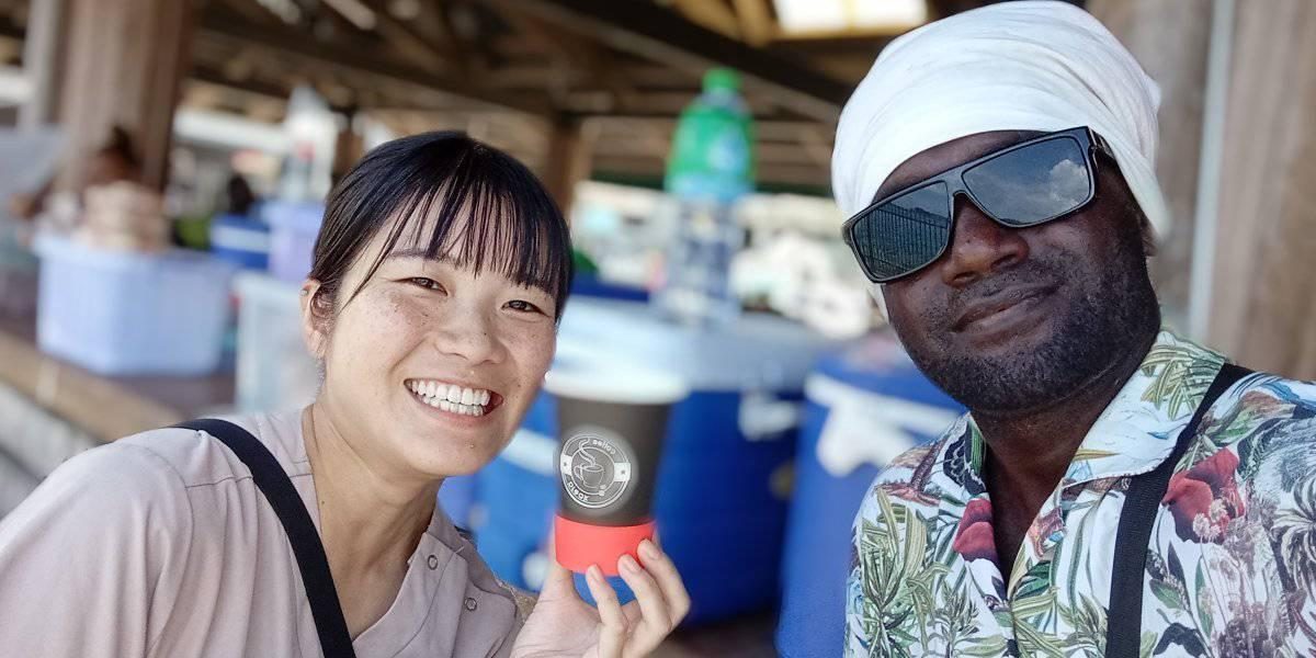 A Japanese visitor having a taste of the much loved juice