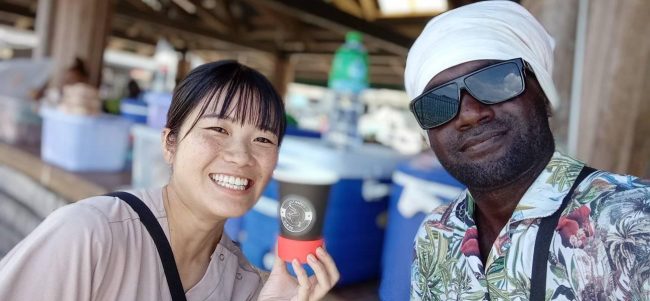 A Japanese visitor having a taste of the much loved juice