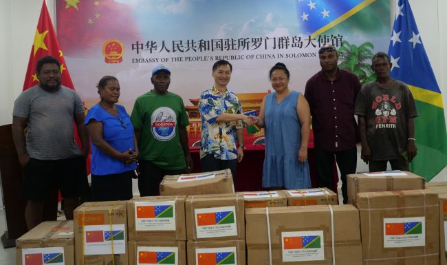 Ambassador Cai shaking hands with MP Douglas during the handover. With them is CDO Manebona (second from right) and constituency reps