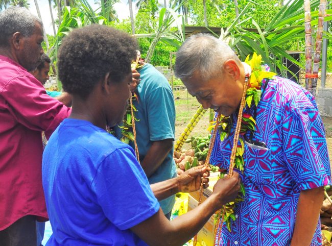 Former Chairlady of Areatakiki Mary Seleo garland Ambassador Miwa Yoshiaki with Guadalcanal traditional money.