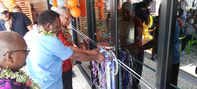 Malaita Province Premier Elijah Asilau with solomon post Board chairman James Apania cutting the ribbon to officially open the new solomon post office in Auki. Photos. SOLOMON LOFANA