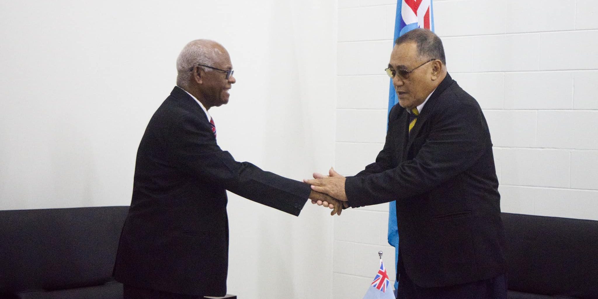 Sir John Muria shakes hand with the Governor General of Tuvalu, Sir Reverend Tofinga Vaevalu Falani after signing his contract. Photo by Tuvalu Government Media