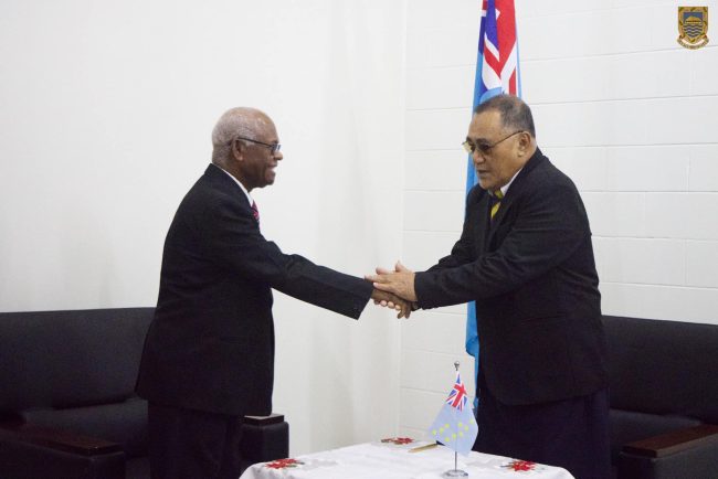 Sir John Muria shakes hand with the Governor General of Tuvalu, Sir Reverend Tofinga Vaevalu Falani after signing his contract. Photo by Tuvalu Government Media