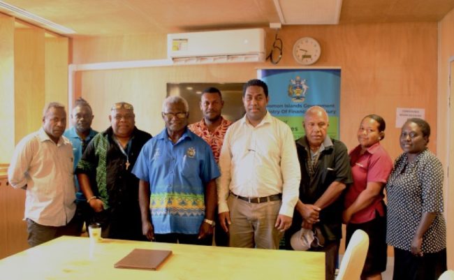 The Minister of Finance and Treasury Manasseh Sogavare with the Acting Government Statistician Samson Kanamoli and the Heads and representatives of the NSO Units.