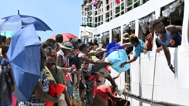 Travellers boarding an overloaded passenger vessel