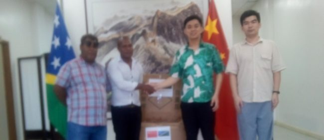 UKFC Vice president Solomon Timmy far left and his secretary John Murite;e receive the sporting equipment’s from representative of PRC in Honiara