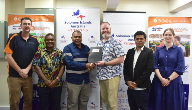 Australian High Commission Infrastructure Counsellor hands over Early Works document to Alrico with representatives from Malaita Provincial Government