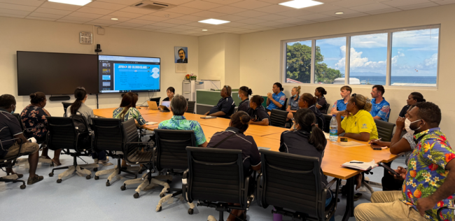 Officials listening to the final presentations