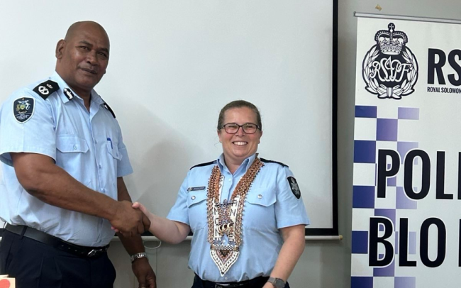 RSIPF Commissioner, Mostyn Mangau, presenting awards to Detective Sergeant Schumacher