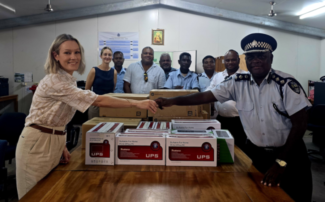 DFAT rep hands over the donation to director prosecution chief superintendent Rodney Wheatney.
