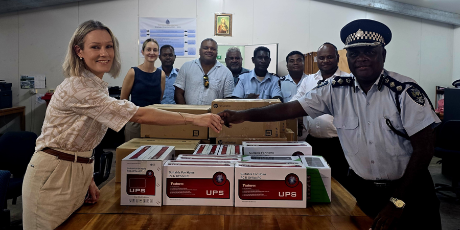 DFAT rep hands over the donation to director prosecution chief superintendent Rodney Wheatney.