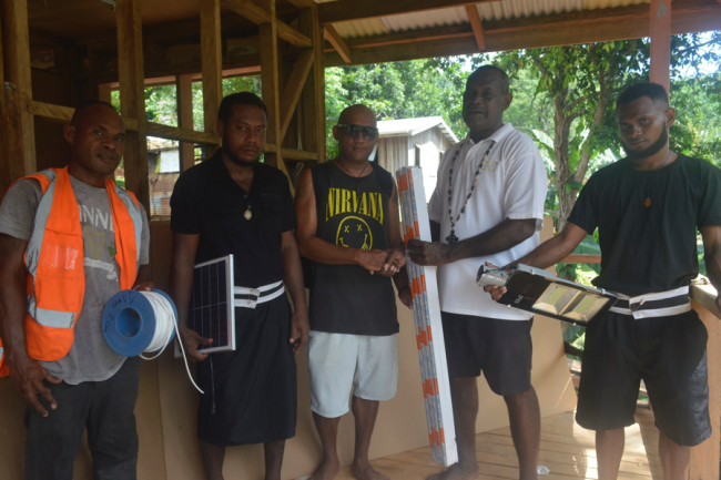 Gizo-Kolombangar Constitunecy Project Officer Lezutuni handing over the solar accessories and equipment to Father Barclay Voze of Gizo St Luke Diocese of the Anglican Church of Melanesia