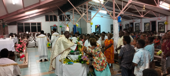 Fr John Adai conducts baptism on Easter Saturday at Fasitoro as part of Easter celebration. Photo Solomon Lofana