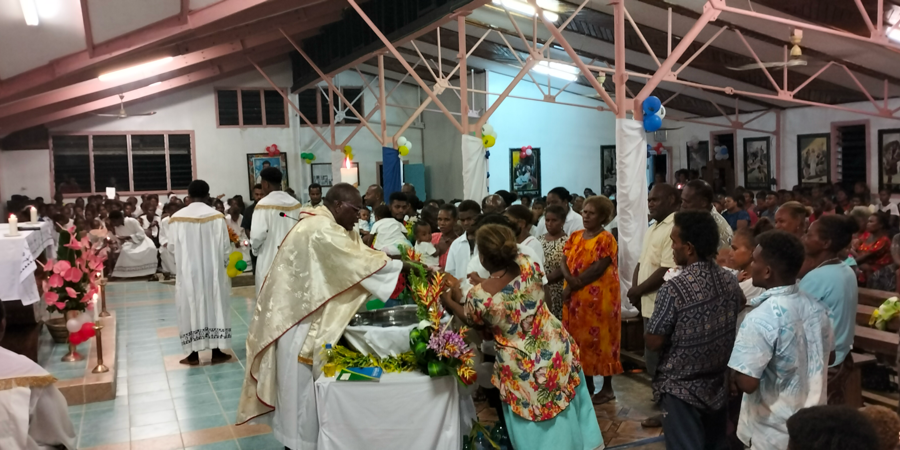 Fr John Adai conducts baptism on Easter Saturday at Fasitoro as part of Easter celebration. Photo Solomon Lofana