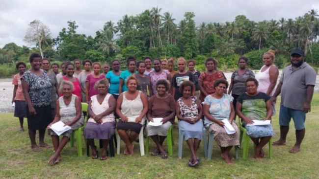 Ghombua Women’s Savings Group take group with the facilitator Mr Mac Joe Luvu at Ghombua after the training