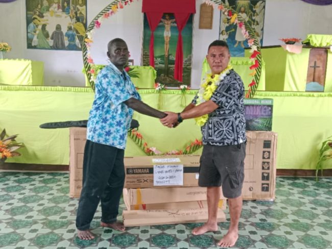 Jacob Kwan handing over the Musical Instrumental to UN Pastor Dido at the Supato Church in South Vella WP